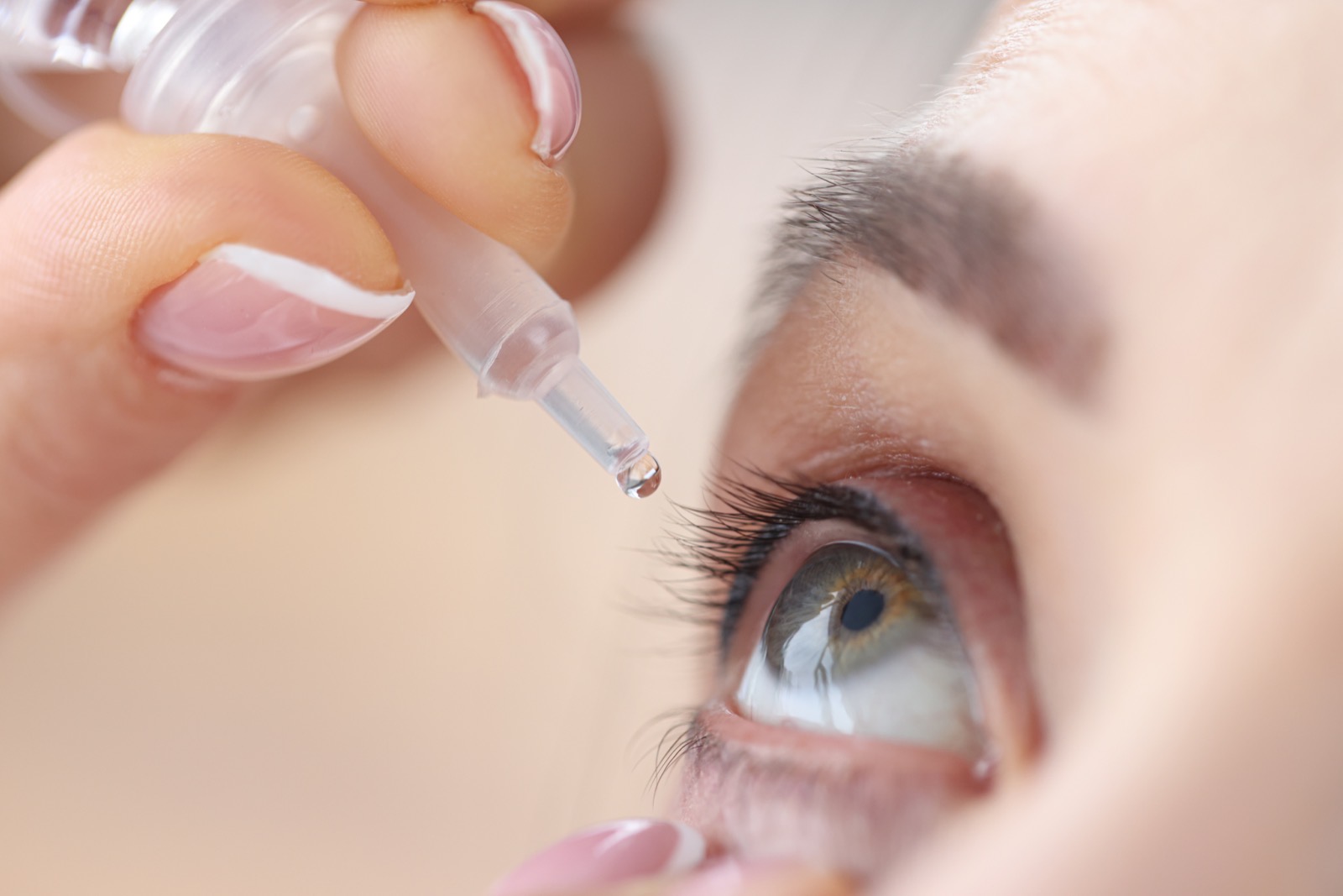 Close-up of eye drops being applied — artificial tears are a first-line treatment for dry eye